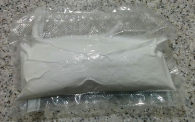 A sealed bag containing prints surrounded by salt powder